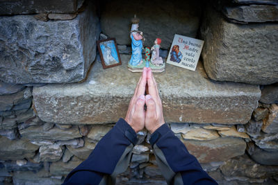 Low section of man standing on stone wall