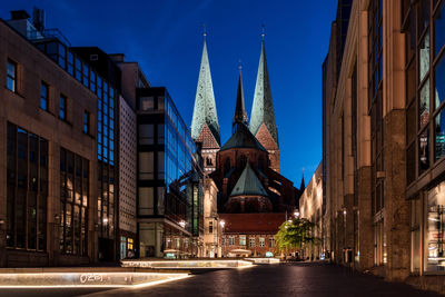 View of illuminated cathedral against blue sky