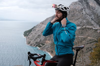 Young man riding bicycle on mountain