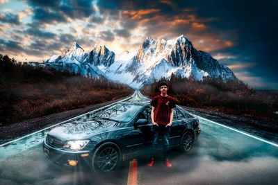 Rear view of man on road against snowcapped mountain