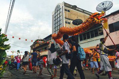 People celebrating chinese new year on street in city