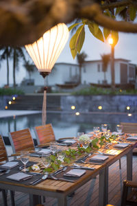 Tables and chairs by swimming pool at resort