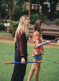 Full length of happy woman standing on grass