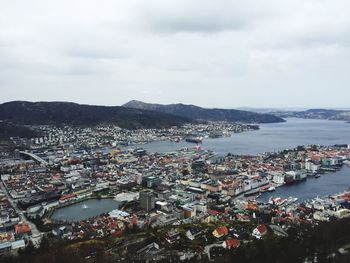 View of cityscape against cloudy sky