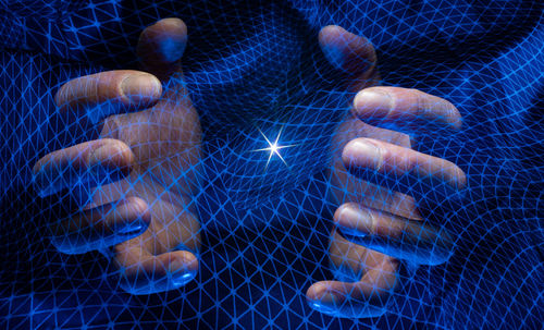 Close-up of human hand against blue background