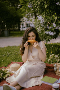 Portrait of young woman eating food