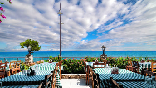 Cyprus sea coast and typical restaurant terrace under sunny cloudy sky in the morning 