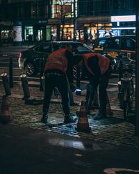 Man standing in city at night