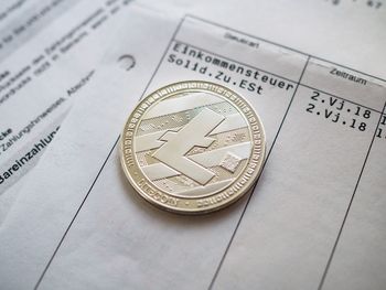 High angle view of coin on paper