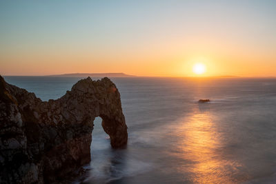 Long exposure of the calm sea at durdle door at dusk