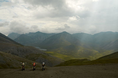 People on mountains against sky