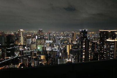 High angle view of illuminated buildings in city at night