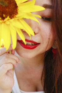 Close-up portrait of woman holding flower