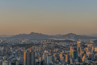 Cityscape against clear sky during sunset