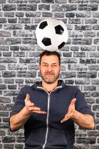 Portrait of a smiling man against wall