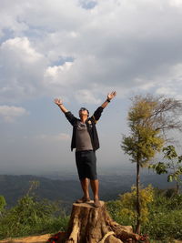 Full length of man climbing on mountain against sky