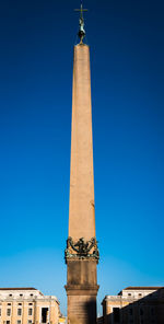 Low angle view of tower against blue sky