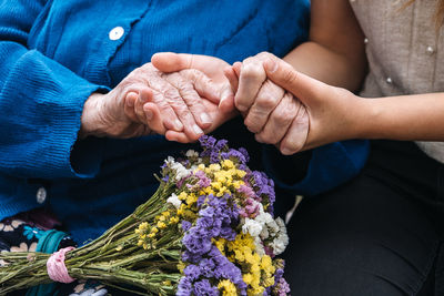 Midsection of man holding hands