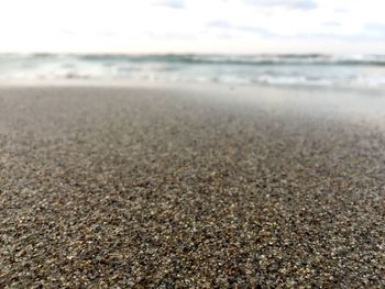 Close-up of sand on beach against sky