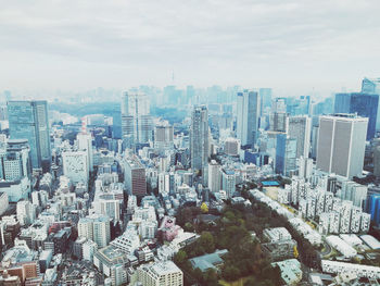 Aerial view of modern buildings in city against sky