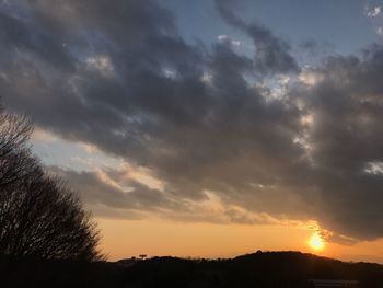 Scenic view of dramatic sky over silhouette landscape