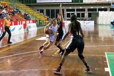 Group of people playing basketball court