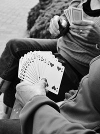 Close-up of man playing with tattoo on table