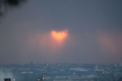 Aerial view of cityscape against sky during sunset