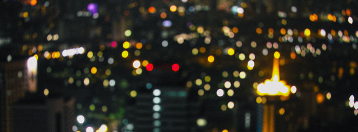 Defocused image of illuminated city at night