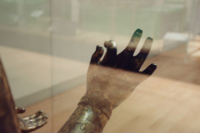 Close-up of human hand on floor