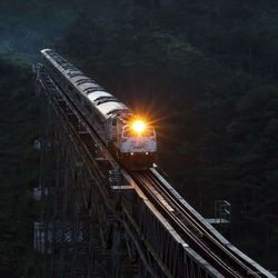 Low angle view of illuminated bridge against sky at night