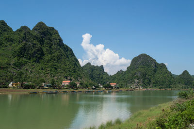 Scenic view of sea and mountains against sky