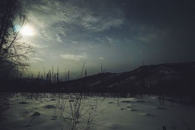 Scenic view of lake against sky at night