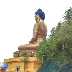 Low angle view of statue against temple