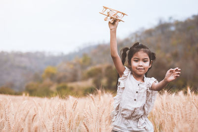 Girl playing in wheat field