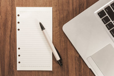 High angle view of laptop and book on table