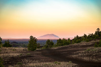 Scenic view of field against sky during sunset