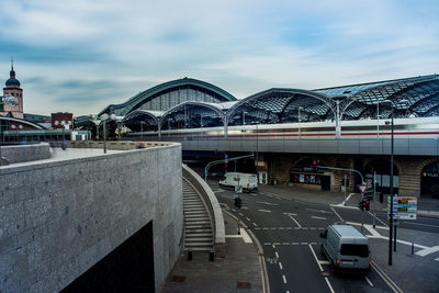 Bridge over road against sky in city