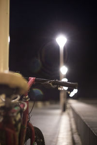 Man and illuminated light painting on wall at night