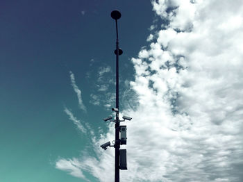 Low angle view of street light against cloudy sky