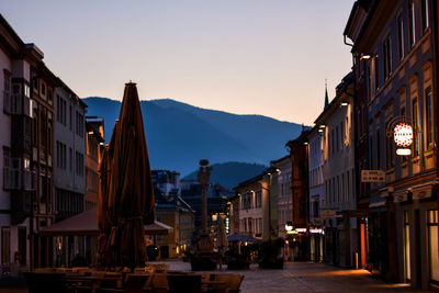 Buildings in city at sunset