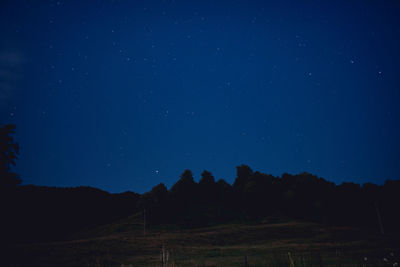 Scenic view of landscape against blue sky at night