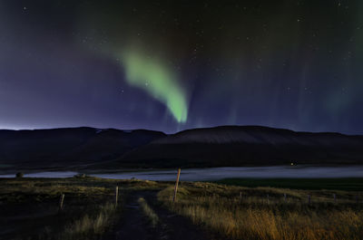 Scenic view of lake against sky at night