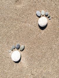 High angle view of pebbles on sand