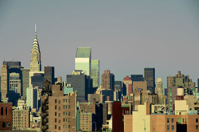 Modern buildings in city against clear sky