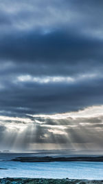 Scenic view of sea against dramatic sky