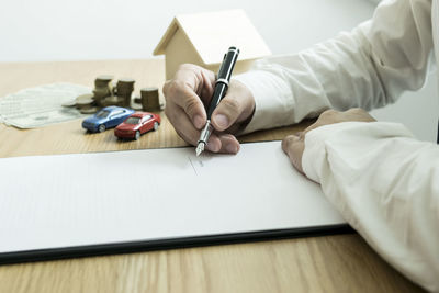 Close-up of business person working at desk in office