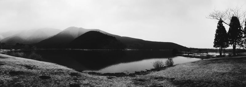 Scenic view of lake by mountains against clear sky