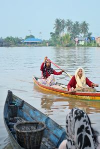 People sitting on boat in sea