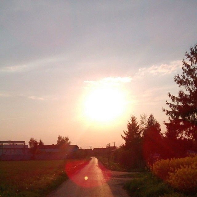 the way forward, transportation, sunset, road, diminishing perspective, vanishing point, sky, sun, country road, tree, orange color, sunlight, landscape, tranquil scene, tranquility, nature, sunbeam, cloud - sky, beauty in nature, scenics